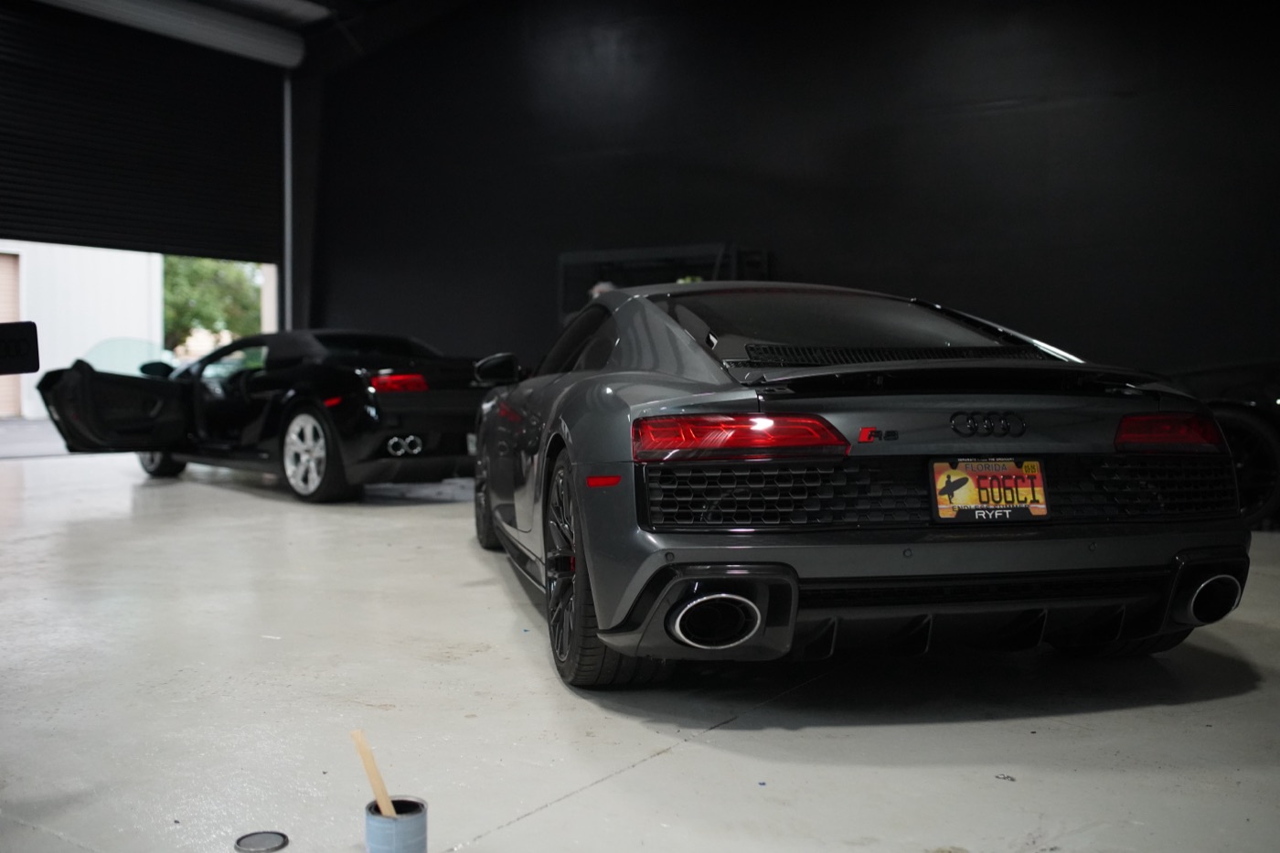 Gray Audi R8 in the dark shop bay