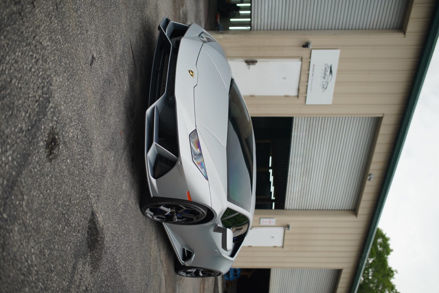 Lamborghini Huracán in matte silver outside the shop