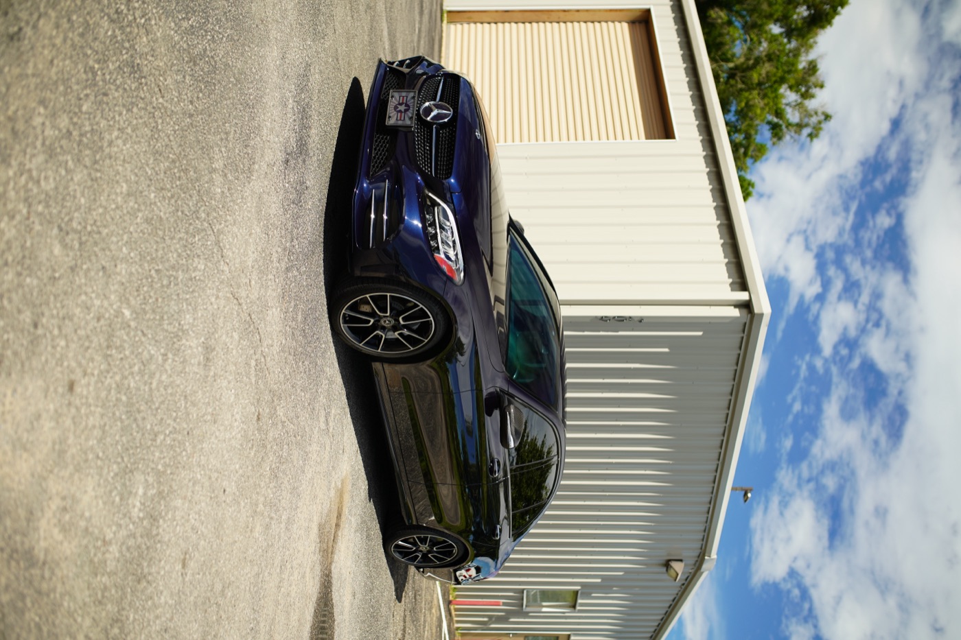 Blue Mercedes coupe outside the shop